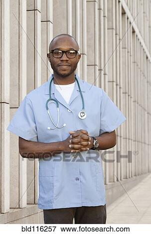 Stock Photo - Black doctor standing on city street. Fotosearch
