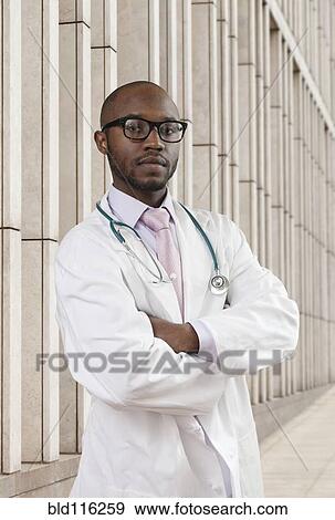 Stock Photo - Black doctor standing on city street. Fotosearch