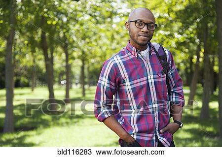 Black man smiling in park View Large Photo Image Stock Image - Black man smiling in park. Fotosearch