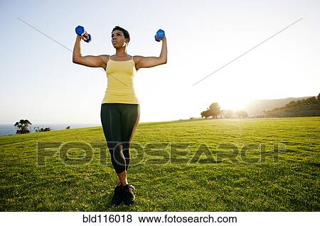 Black woman lifting weights in rural landscape View Large Photo Image Stock Photo - Black woman lifting weights in rural landscape. Fotosearch