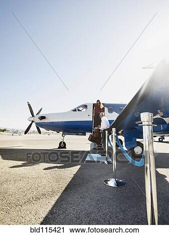 Business people disembarking airplane on runway View Large Photo Image Stock Image - Business people disembarking airplane on runway. Fotosearch