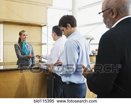 Business people in line at airport front desk View Large Photo Image Stock Photography - Business people in line at airport front desk. Fotosearch