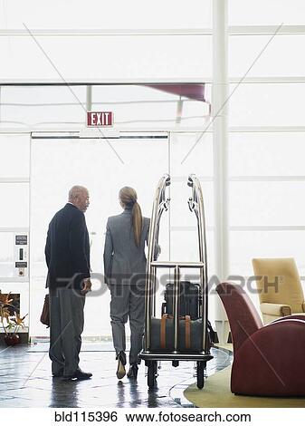 Business people talking in hotel lobby View Large Photo Image Stock Photograph - Business people talking in hotel lobby. Fotosearch