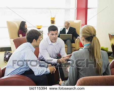 Picture - Business people talking in lobby. Fotosearch