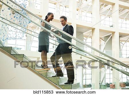 Business people talking on staircase View Large Photo Image Stock Image - Business people talking on staircase. Fotosearch