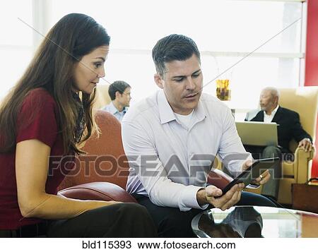 Stock Image - Business people using digital tablet. Fotosearch