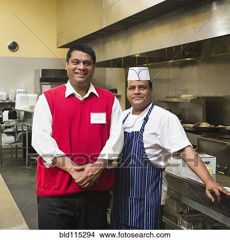 Picture - Businessman and chef standing in kitchen. Fotosearch