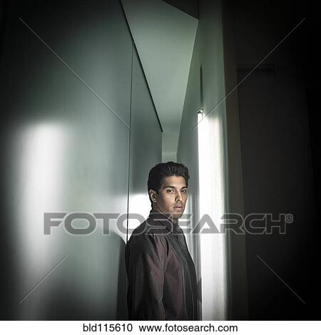 Stock Image - Businessman in narrow hallway. Fotosearch