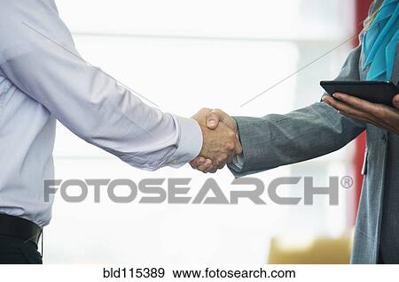 Caucasian business people shaking hands View Large Photo Image Stock Photo - Caucasian business people shaking hands. Fotosearch
