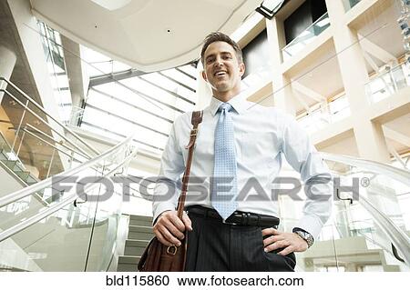 Stock Image - Caucasian businessman on office steps. Fotosearch