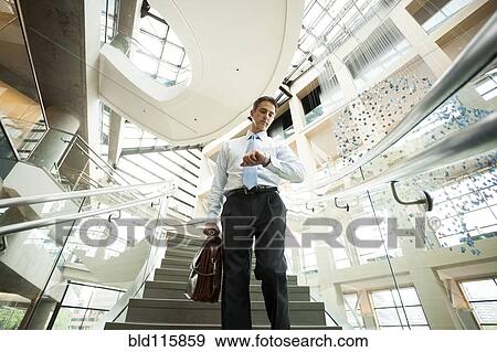Caucasian businessman on office steps View Large Photo Image Stock Photo - Caucasian businessman on office steps. Fotosearch