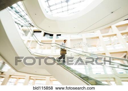 Caucasian businessman rushing on office staircase View Large Photo Image Stock Photo - Caucasian businessman rushing on office staircase. Fotosearch