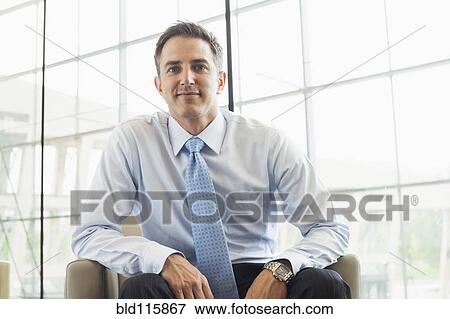 Stock Photo - Caucasian businessman sitting in armchair. Fotosearch