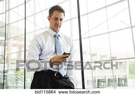 Picture - Caucasian businessman using cell phone. Fotosearch