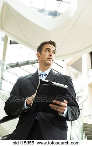 Caucasian businessman using digital tablet View Large Photo Image Stock Photography - Caucasian businessman using digital tablet. Fotosearch