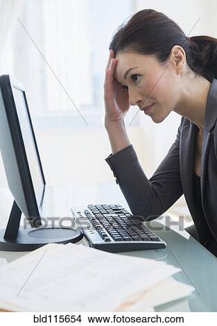 Picture - Caucasian businesswoman working at desk. Fotosearch