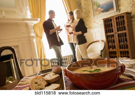 Caucasian friends talking in dining room View Large Photo Image Stock Photo - Caucasian friends talking in dining room. Fotosearch