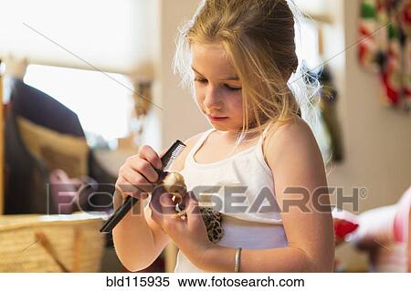 Caucasian girl combing doll's hair View Large Photo Image Stock Photography - Caucasian girl combing doll's hair. Fotosearch