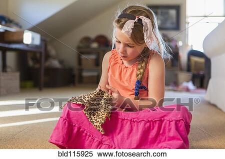 Stock Photography - Caucasian girl cutting fabric. Fotosearch