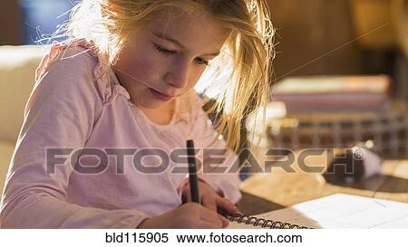 Caucasian girl doing homework on desk View Large Photo Image Stock Photography - Caucasian girl doing homework on desk. Fotosearch