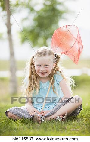 Stock Photo - Caucasian girl holding butterfly net. Fotosearch