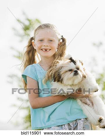 Caucasian girl holding dog outdoors View Large Photo Image Stock Image - Caucasian girl holding dog outdoors. Fotosearch