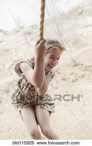 Caucasian girl on rope swing View Large Photo Image Stock Photograph - Caucasian girl on rope swing. Fotosearch
