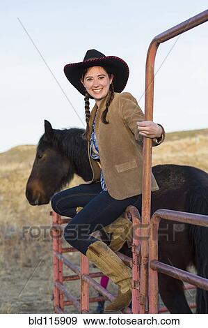 Stock Photo - Caucasian girl petting horse on farm. Fotosearch