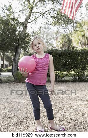 Caucasian girl playing in backyard View Large Photo Image Stock Photo - Caucasian girl playing in backyard. Fotosearch