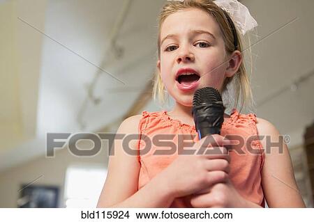 Caucasian girl singing karaoke at home View Large Photo Image Picture - Caucasian girl singing karaoke at home. Fotosearch