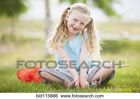 Caucasian girl smiling in grass View Large Photo Image Stock Photograph - Caucasian girl smiling in grass. Fotosearch