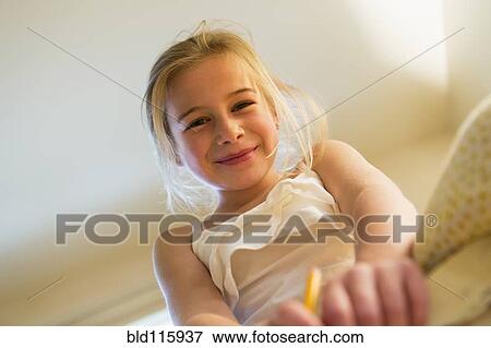 Stock Photo - Caucasian girl smiling indoors. Fotosearch