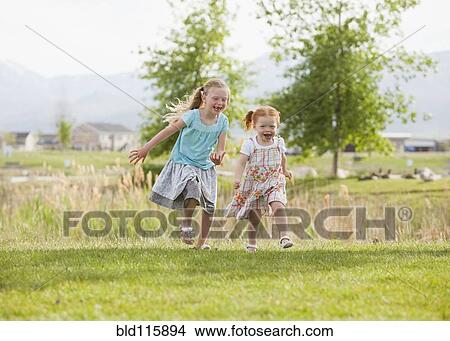 Caucasian girls running in grass View Large Photo Image Picture - Caucasian girls running in grass. Fotosearch