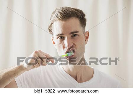 Caucasian man brushing his teeth View Large Photo Image Stock Image - Caucasian man brushing his teeth. Fotosearch