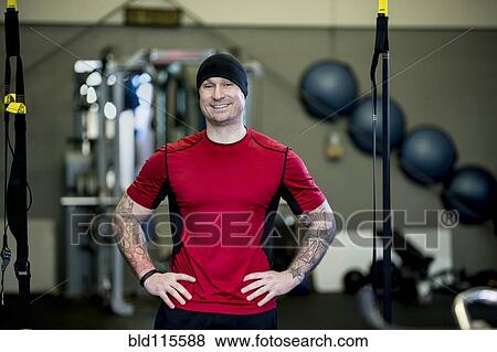 Stock Photo - Caucasian man smiling in gym. Fotosearch