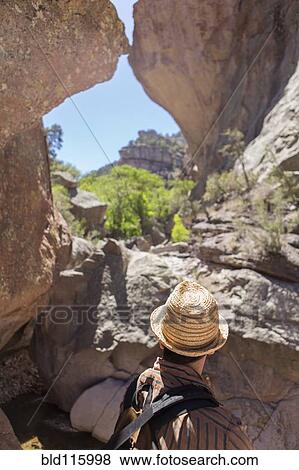 Stock Photo - Caucasian man viewing rock formation. Fotosearch