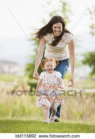 Caucasian mother and daughter playing outdoors View Large Photo Image Stock Image - Caucasian mother and daughter playing outdoors. Fotosearch