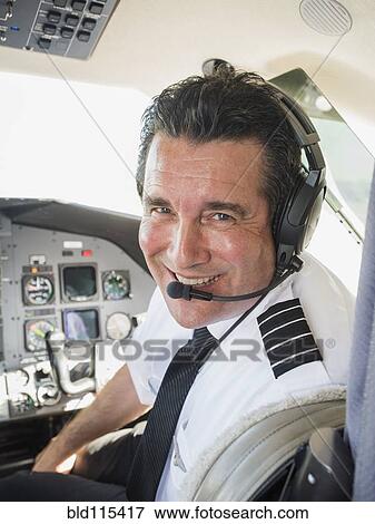 Caucasian pilot in airplane cockpit View Large Photo Image Stock Photo - Caucasian pilot in airplane cockpit. Fotosearch