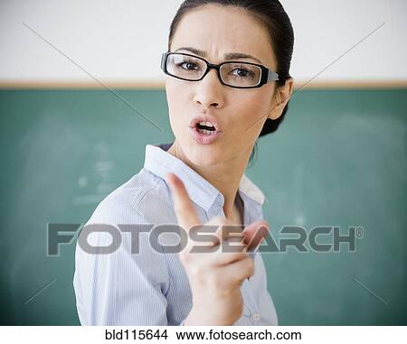 Picture - Caucasian teacher scolding in classroom. Fotosearch