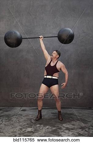 Caucasian weight lifter holding weights View Large Photo Image Stock Photography - Caucasian weight lifter holding weights. Fotosearch