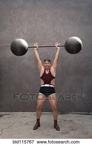 Stock Photo - Caucasian weight lifter straining. Fotosearch