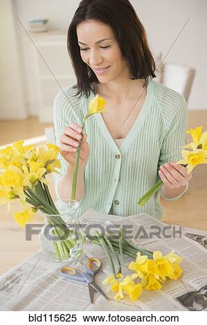 Stock Photography - Caucasian woman arranging flowers. Fotosearch