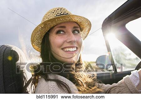 Stock Image - Caucasian woman driving convertible. Fotosearch