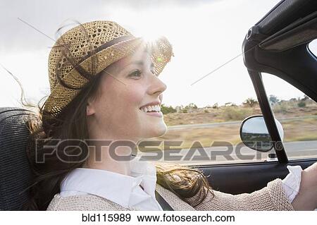Stock Photo - Caucasian woman driving convertible. Fotosearch