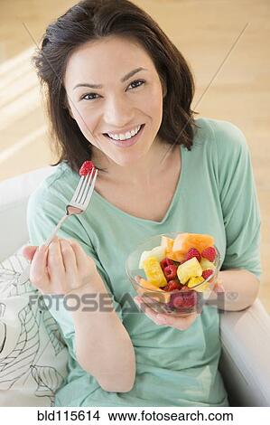 Caucasian woman eating fruit View Large Photo Image Picture - Caucasian woman eating fruit. Fotosearch