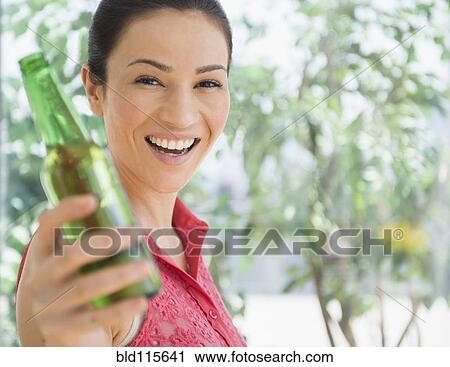 Caucasian woman holding bottle of beer View Large Photo Image Stock Image - Caucasian woman holding bottle of beer. Fotosearch