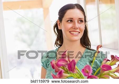 Caucasian woman holding flowers View Large Photo Image Stock Photo - Caucasian woman holding flowers. Fotosearch