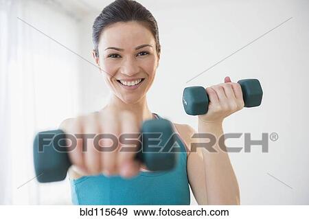 Stock Photo - Caucasian woman lifting weights. Fotosearch