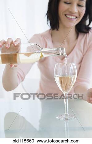 Caucasian woman pouring glass of wine View Large Photo Image Stock Image - Caucasian woman pouring glass of wine. Fotosearch