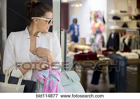 Stock Photo - Caucasian woman shopping in mall. Fotosearch